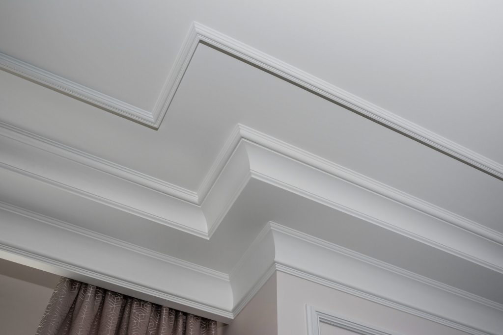 Crown and base moulding installed in a room