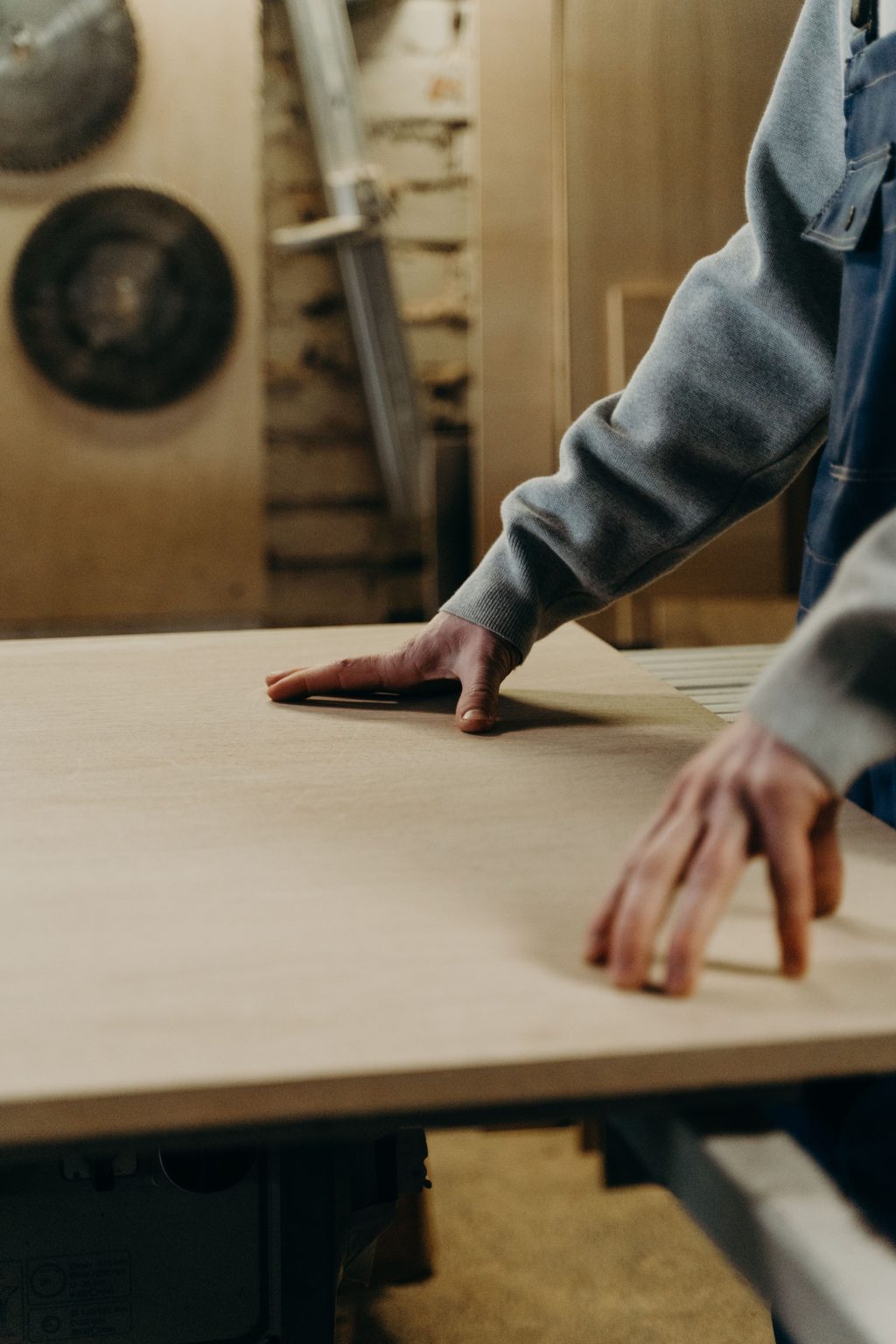 Woodworker checking a panel on the workbench